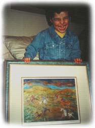 (photo of boy with painting)